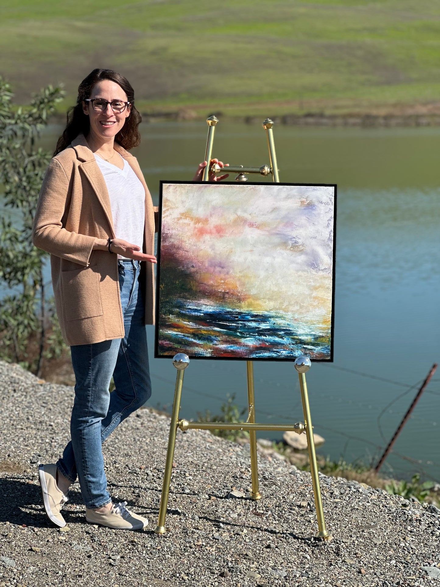 Abstract expressionism oil painting by artist Chelsea Tikotsky. This textured landscape captures a sea as fog rolls in during a sunset, soft hues of orange, gold, cool blues. The fog envelops the water, creating tranquil & mysterious atmosphere, while the sun’s fading light reflects on the surface. Bold strokes & layered textures evoke the quiet, ethereal energy of the scene, blending nature’s beauty with a sense of calm. Perfect for art collectors or as a dramatic, yet serene centerpiece in any home decor