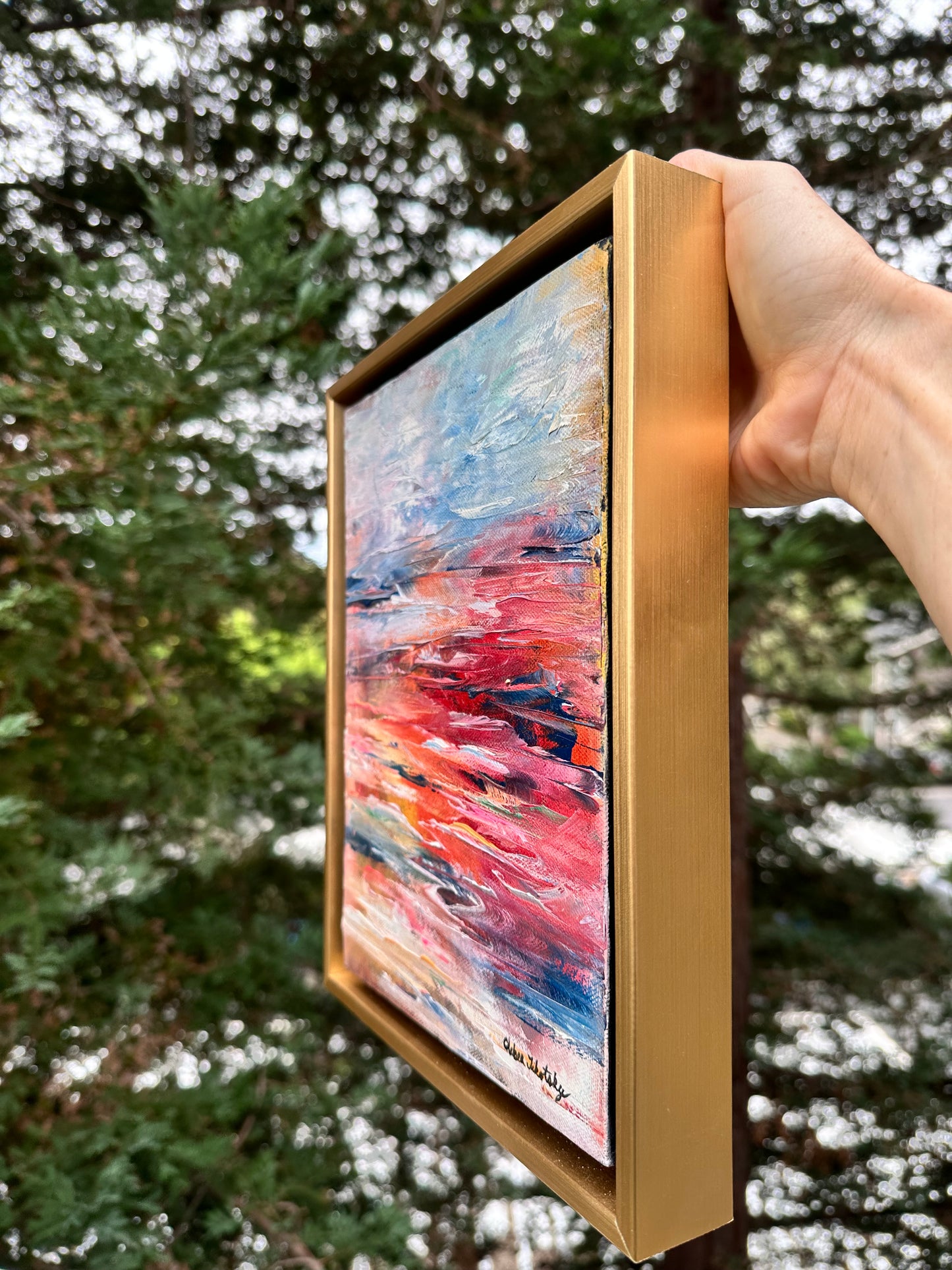 Abstract expressionism oil painting of a seascape at sunset, inspired by The Little Mermaid and a deep love for water, by artist Chelsea Tikotsky. This contemporary artwork features bold, vibrant colors in rich blues, fiery pinks, and shimmering golds, with expressive, flowing brushstrokes capturing the energy and mystery of the ocean at dusk. Ideal for art collectors or as a striking statement piece in home decor, this seascape brings a sense of whimsy, passion, and coastal beauty into any interior space.