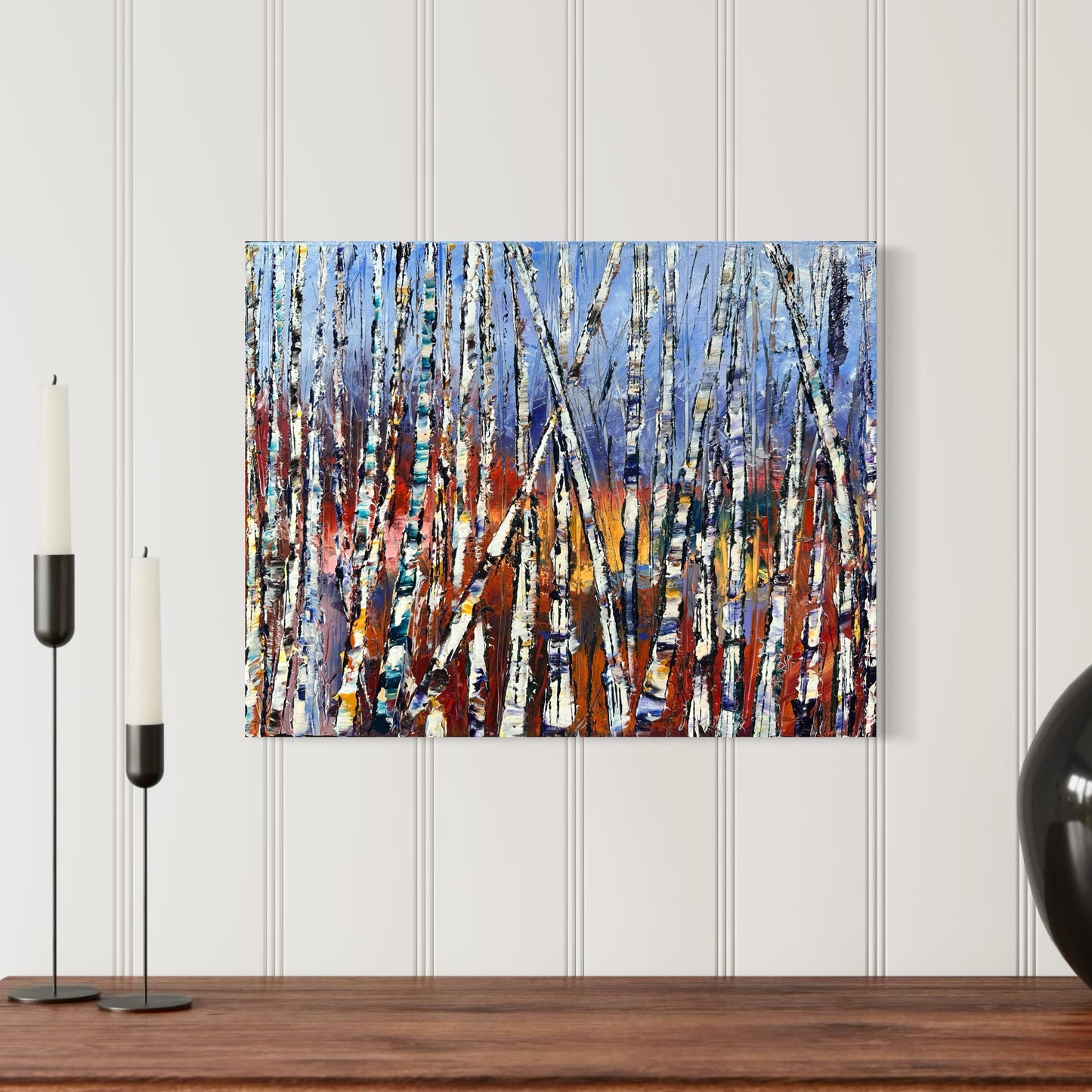 Abstract Birch Tree Forest Oil Painting Textured Landscape Art by artist Chelsea Tikotsky. Step into the vibrant beauty of nature with this original abstract oil painting of a birch tree forest. Featuring thick, textured strokes by palette knife, this artwork showcases striking white birch trees against a background of warm, fiery tones transitioning into cool blues. Perfect for art collectors & interior design enthusiasts, this contemporary masterpiece radiates warmth, energy, & connection to the outdoors.