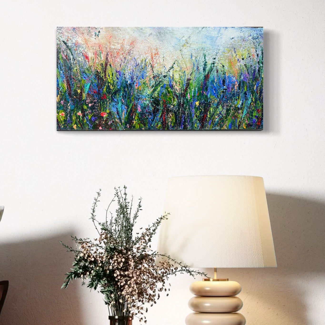 Abstract expressionism oil painting of fields of flowers by artist Chelsea Tikotsky. This contemporary piece features loose, painterly strokes with soft & rich, bold colors, creating a romantic feel. Inspired by nature & floral landscapes, this piece offers texture, movement, & depth, perfect for home decor or art collectors seeking unique abstract art. Ideal for a living room or bedroom space, this statement piece brings warmth, elegance, & a refreshing botanical essence into any interior design.