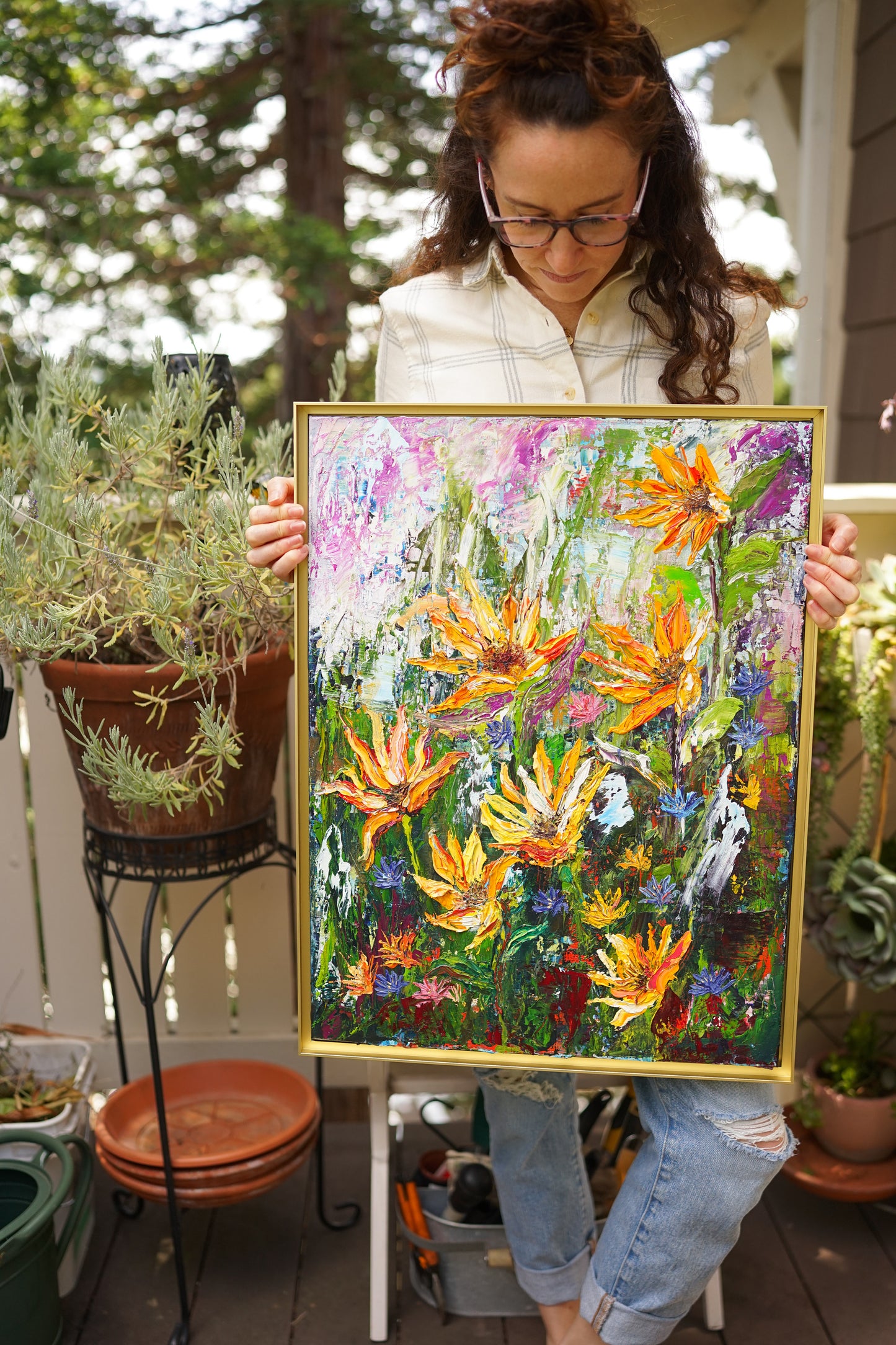 Abstract expressionism oil painting of vibrant sunflowers by artist Chelsea Tikotsky. This contemporary artwork features loose, painterly strokes with a blend of rich, bold colors, creating a romantic feel. Inspired by nature & florals, this large botanical piece offers texture, movement, & depth, perfect for home decor or art collectors seeking unique abstract art. Ideal for a living room, this statement piece brings warmth, elegance, & a refreshing botanical essence into any interior design