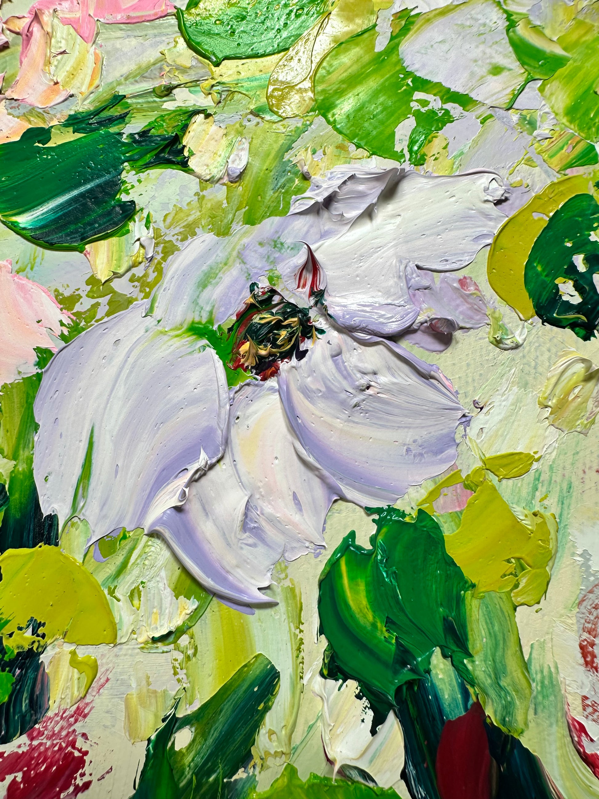 Close-up of a painting with a white flower and green leaves