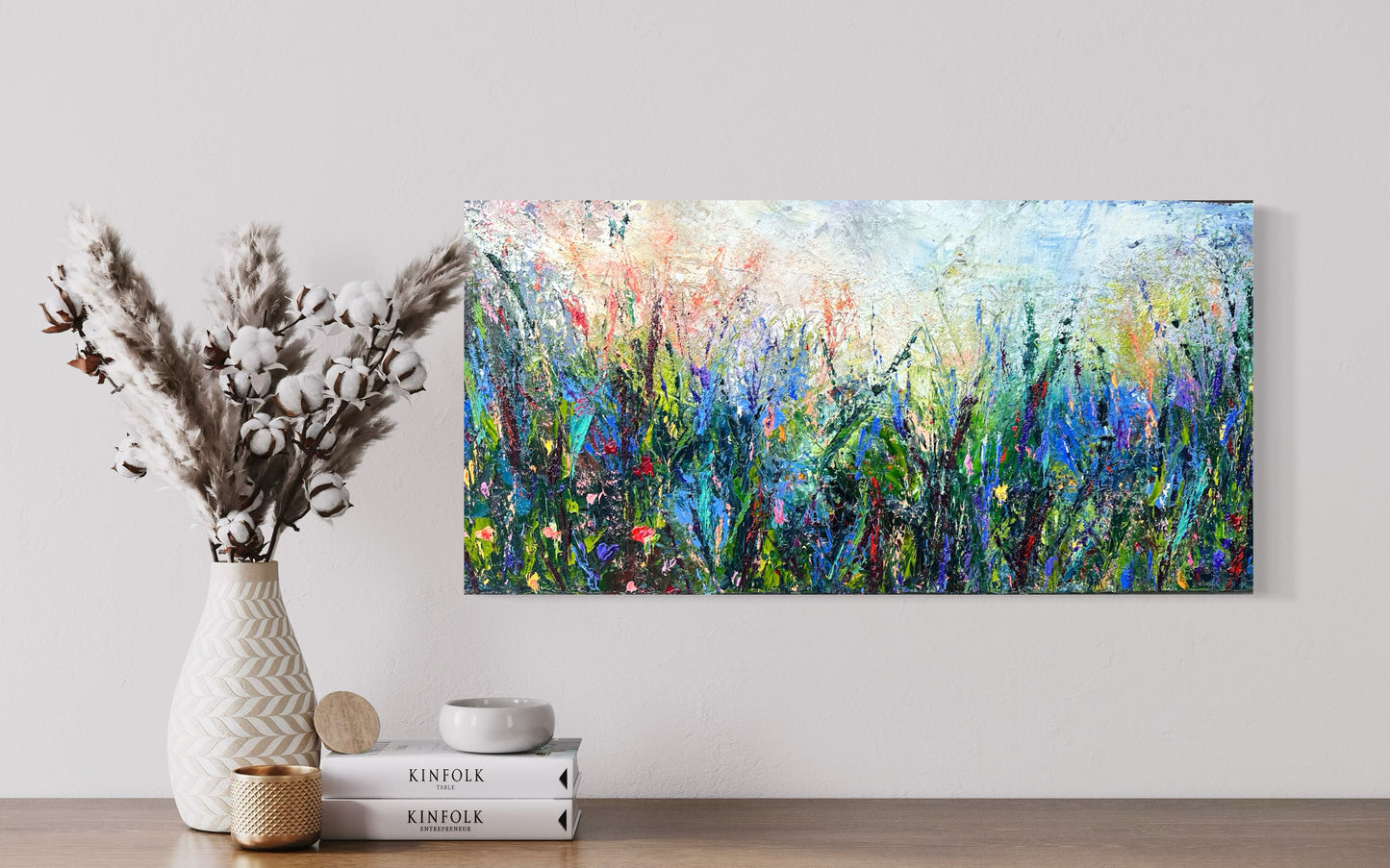 Abstract expressionism oil painting of fields of flowers by artist Chelsea Tikotsky. This contemporary piece features loose, painterly strokes with soft & rich, bold colors, creating a romantic feel. Inspired by nature & floral landscapes, this piece offers texture, movement, & depth, perfect for home decor or art collectors seeking unique abstract art. Ideal for a living room or bedroom space, this statement piece brings warmth, elegance, & a refreshing botanical essence into any interior design.