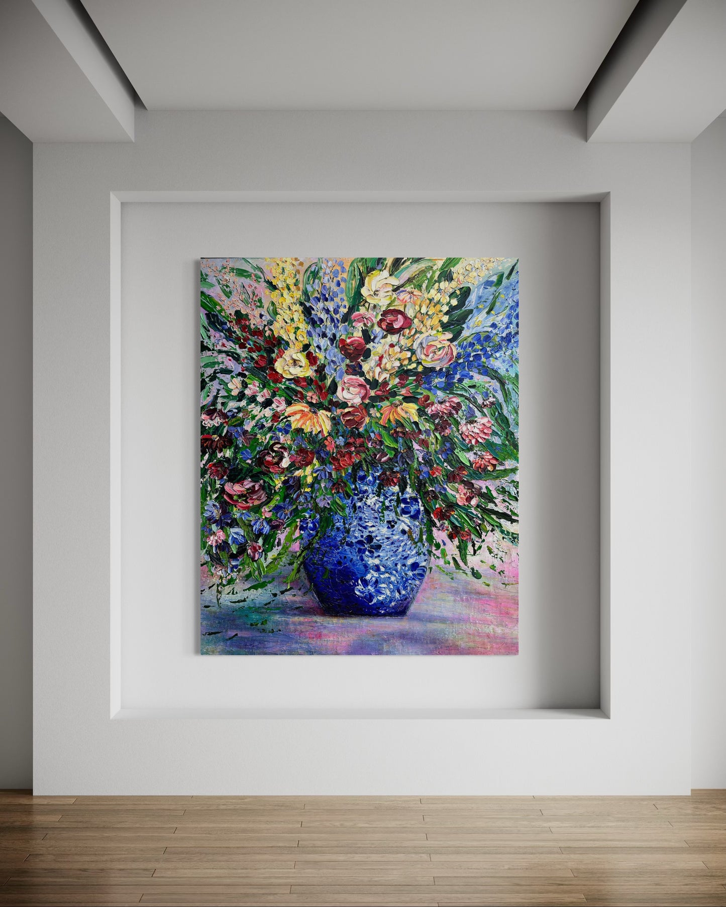 Framed painting of a colorful bouquet with a blue vase on a white wall.