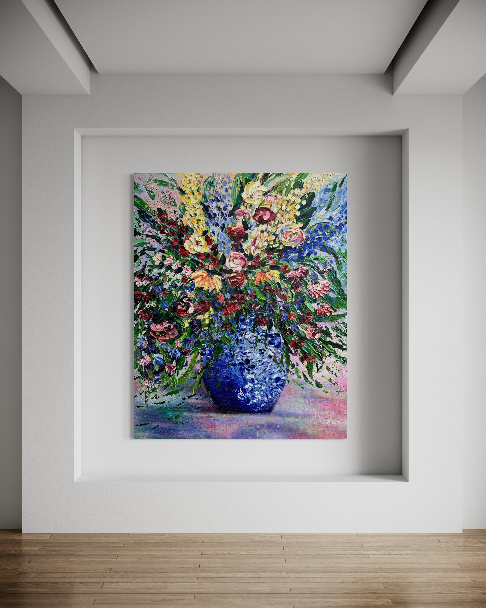 Framed painting of a colorful bouquet with a blue vase on a white wall.