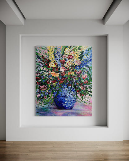 Framed painting of a colorful bouquet with a blue vase on a white wall.